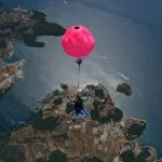 Blue shirt man holding pink balloon