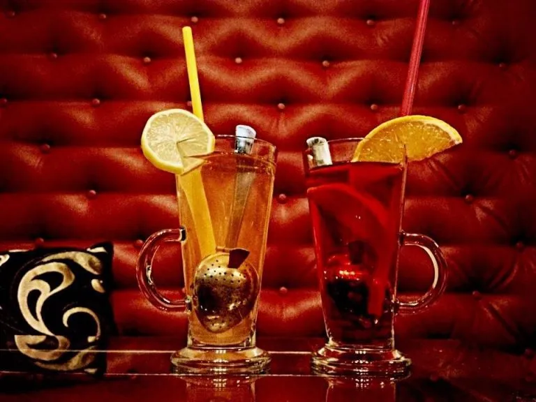 Glass of lemon drink on table