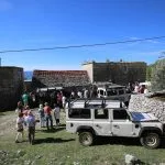 Group at truck in field