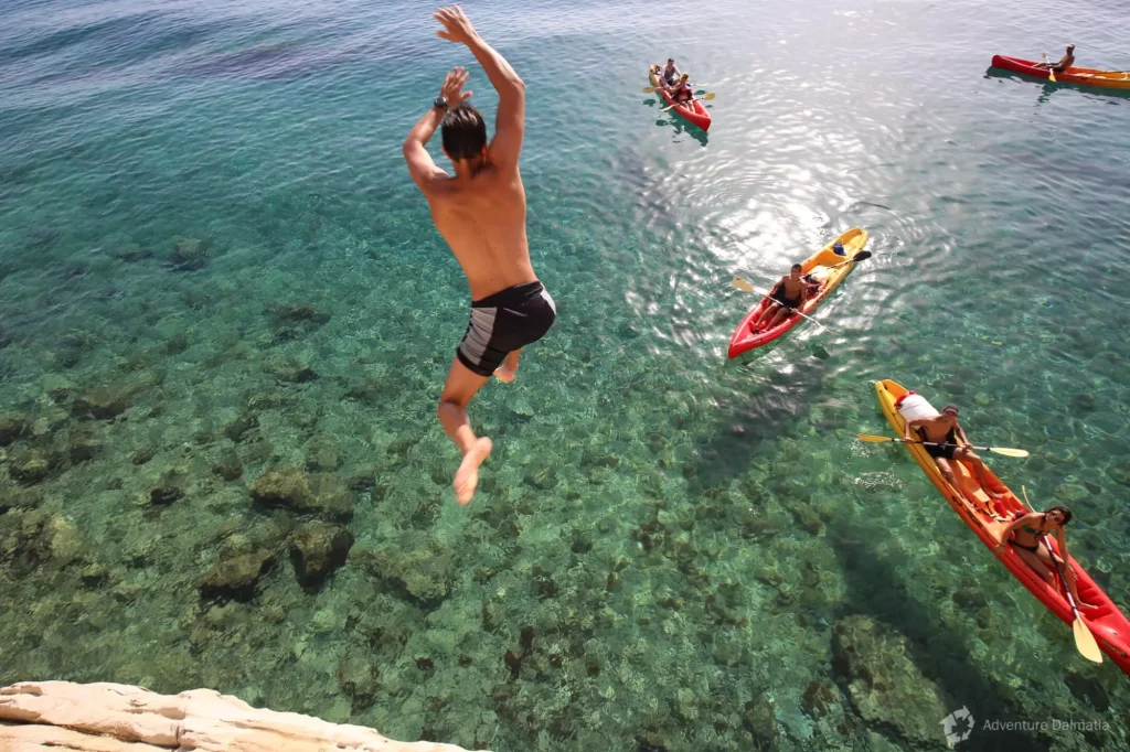 Kayaking and jumping in the sea