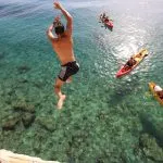 Kayaking and jumping in the sea