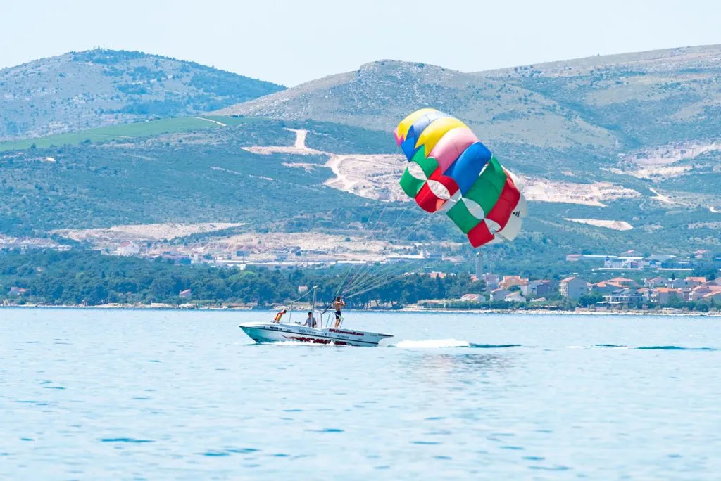 Parasailing boat over blue water