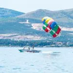 Parasailing boat over blue water