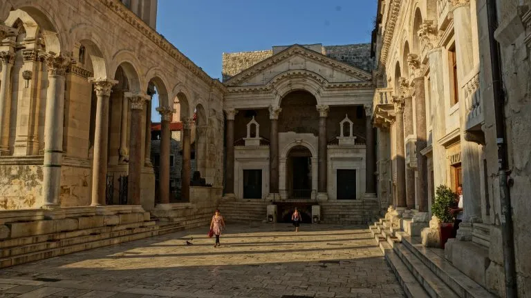 People walking by pillars in split