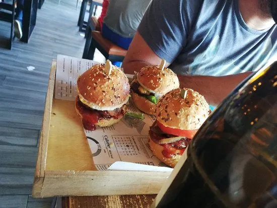 Wooden table with delicious burgers